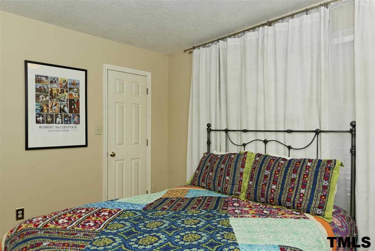 1454 Barton Pl Drive Raleigh, NC 27608 - Photo 17 of 25 a bedroom with a bed and a table