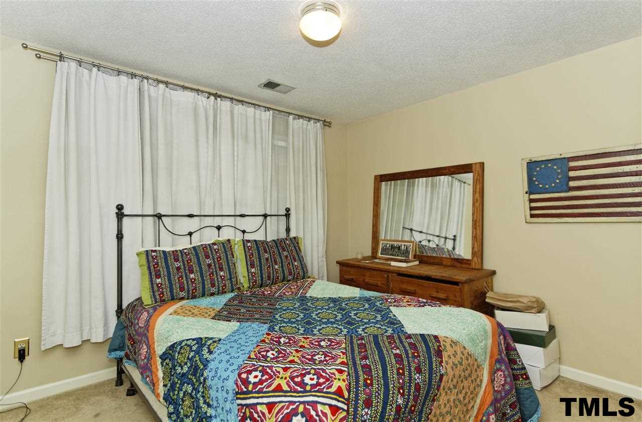 1454 Barton Pl Drive Raleigh, NC 27608 - Photo 18 of 25 a bedroom with a bed and window