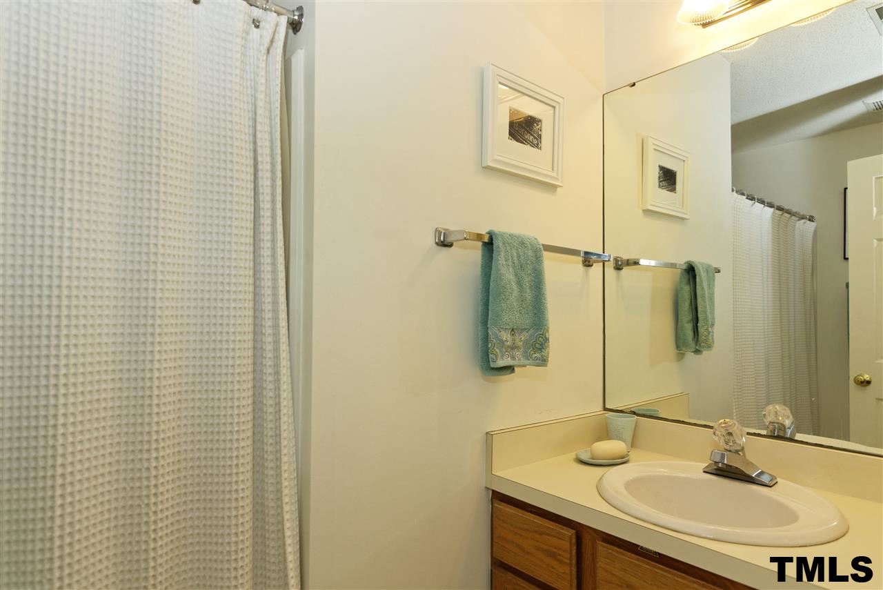 1454 Barton Pl Drive Raleigh, NC 27608 - Photo 20 of 25 a bathroom with a sink and a mirror