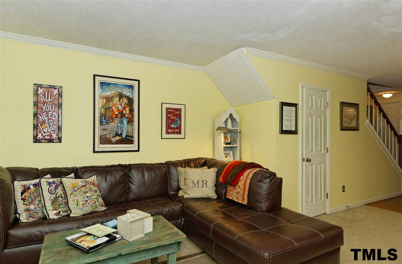 1454 Barton Pl Drive Raleigh, NC 27608 - Photo 5 of 25 a living room with couch and painting on the wall