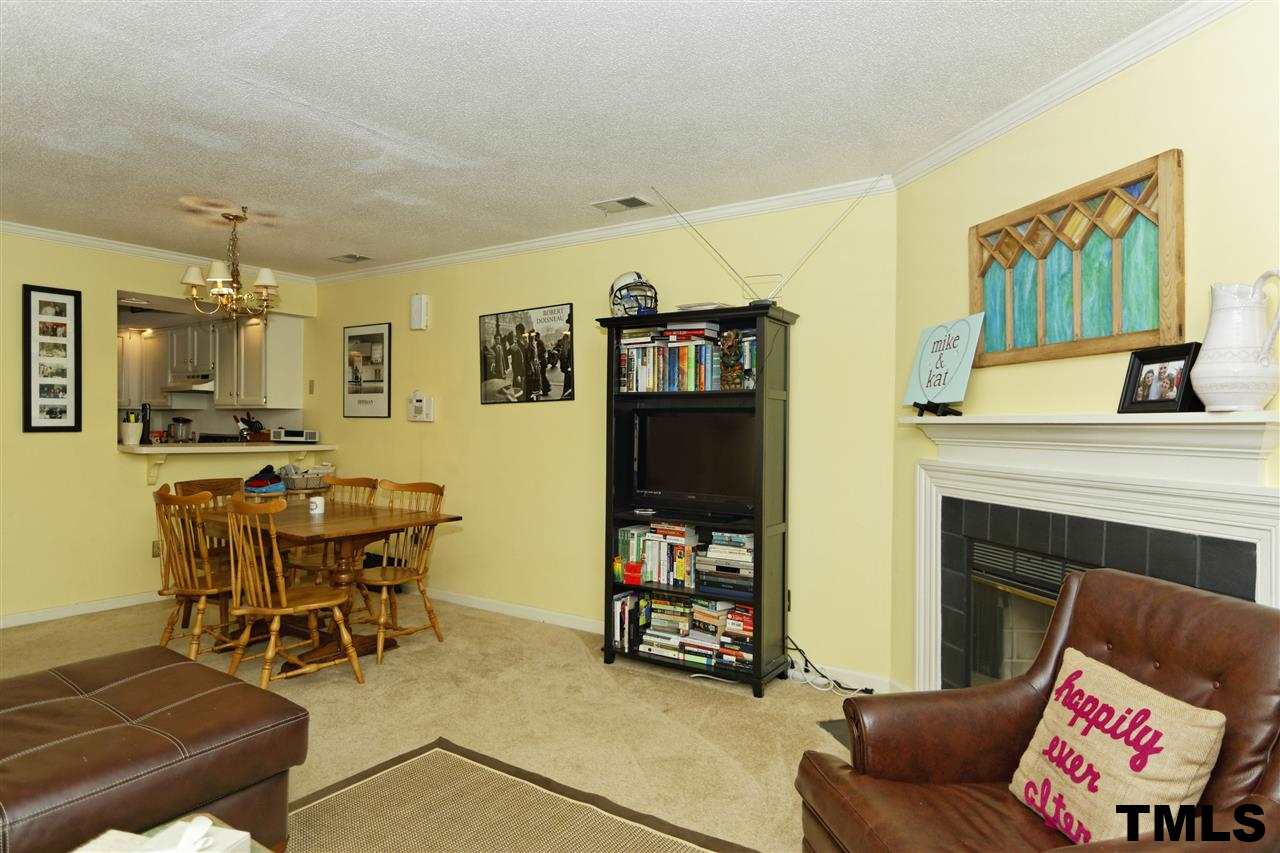 1454 Barton Pl Drive Raleigh, NC 27608 - Photo 6 of 25 a living room with furniture and a fireplace