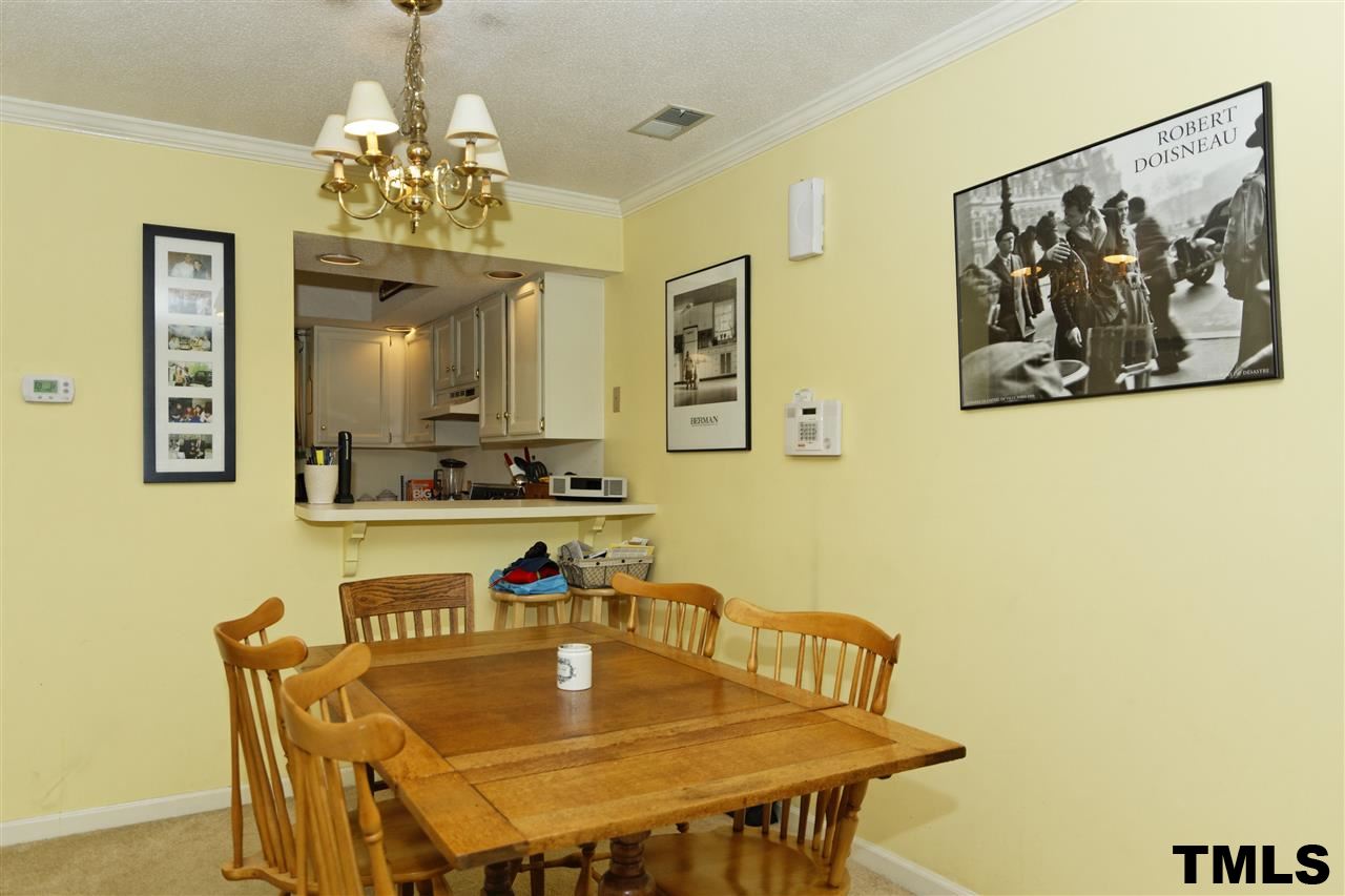 1454 Barton Pl Drive Raleigh, NC 27608 - Photo 8 of 25 a view of a dining room with furniture and chandelier