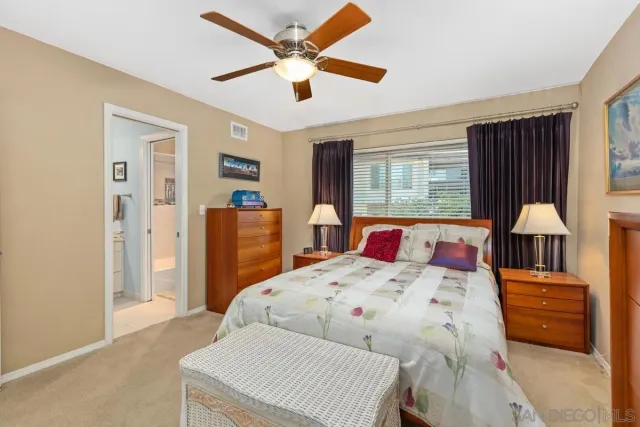 a bedroom with a bed a window and dresser