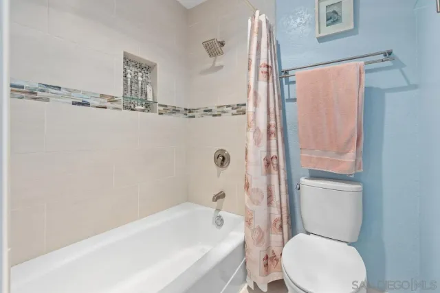 a bathroom with a toilet and a bathtub