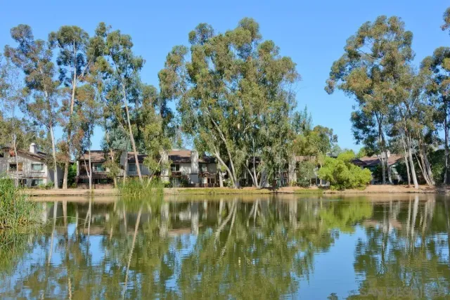 a view of residential houses with outdoor space and lake