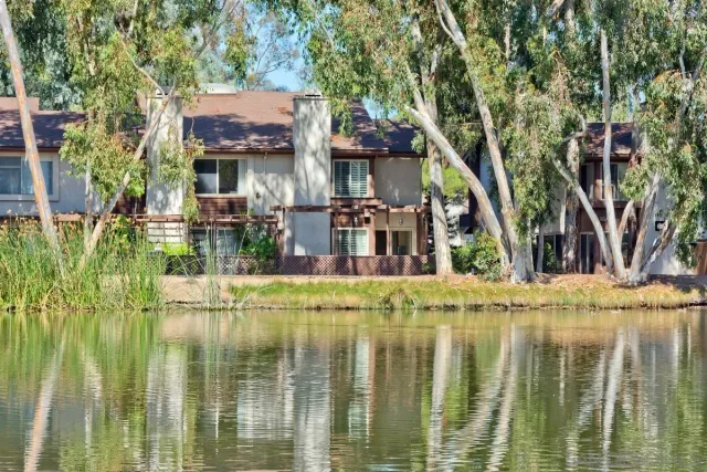 a view of a house with pool and trees
