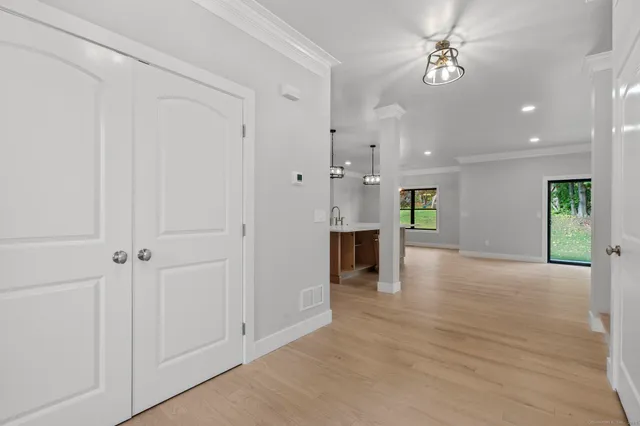 an empty room with a fireplace and windows