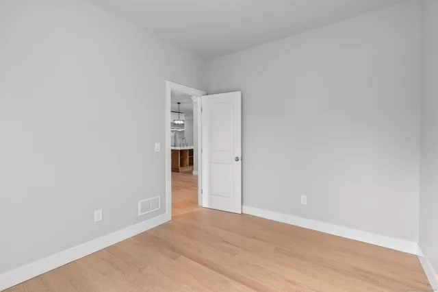 a bathroom with a toilet a sink a vanity and a window