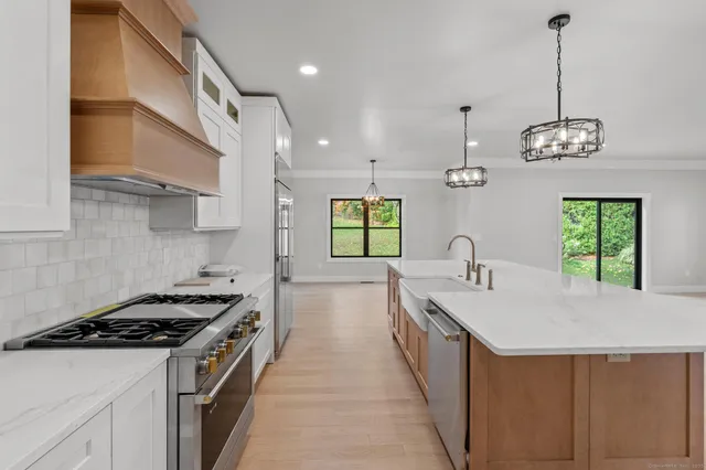 a kitchen with a sink stove and microwave