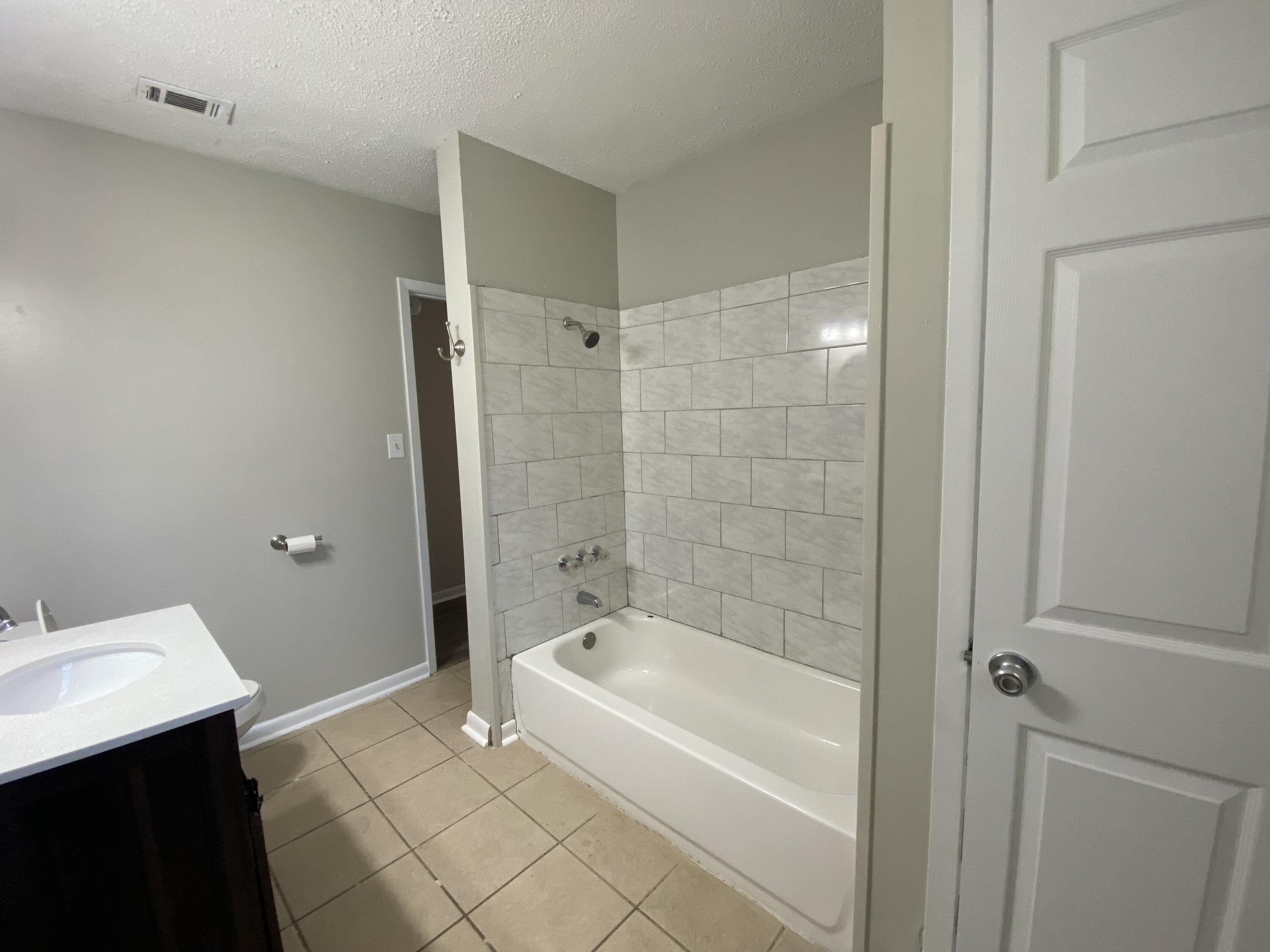 6173 Old Hickory Road Crestview, FL 32539 - Photo 12 of 22 a bathroom with a bathtub and a sink