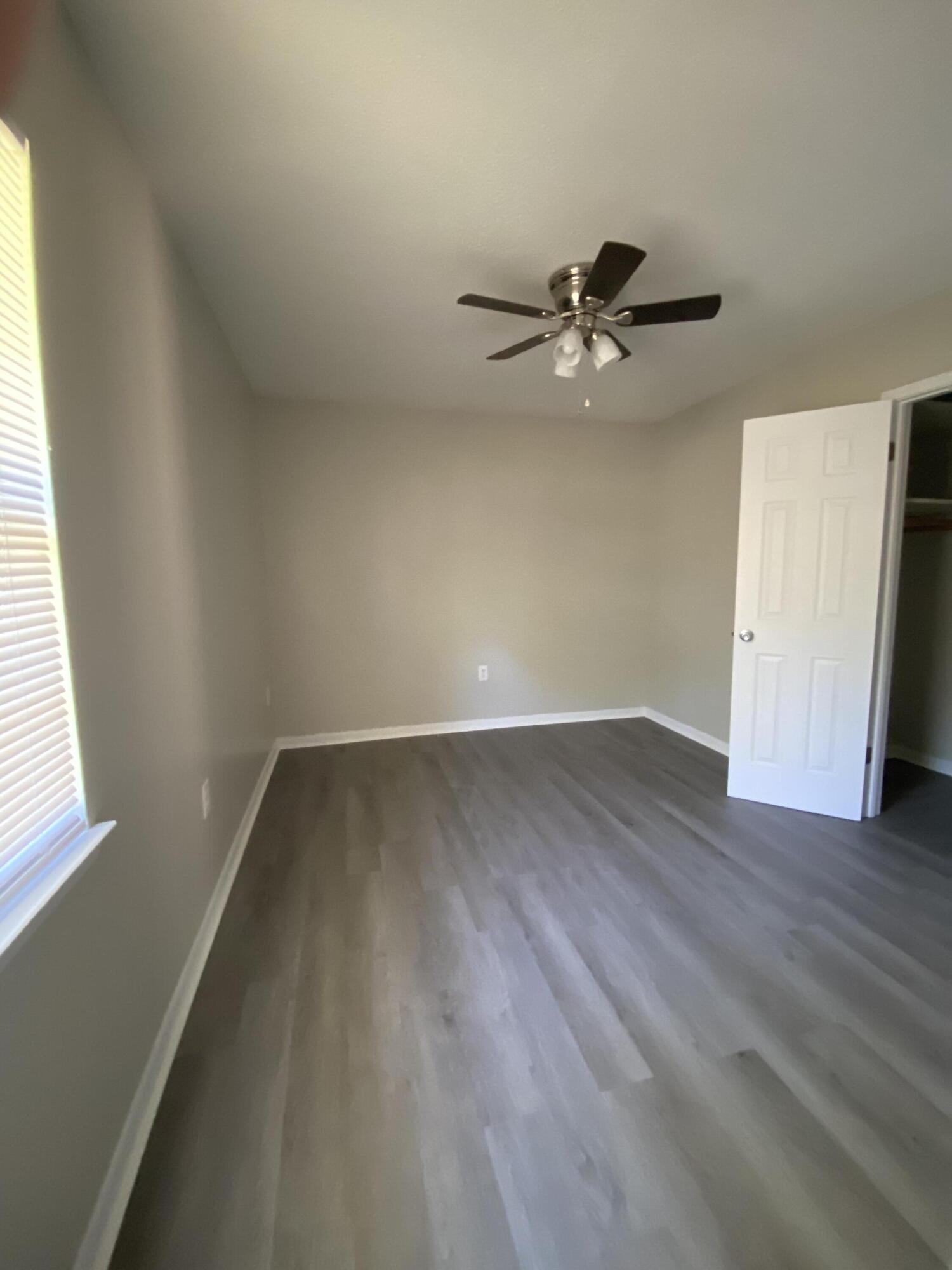 6173 Old Hickory Road Crestview, FL 32539 - Photo 13 of 22 wooden floor in an empty room with a window