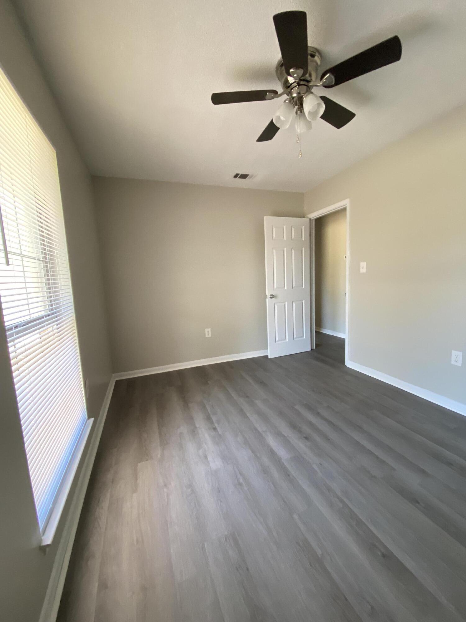 6173 Old Hickory Road Crestview, FL 32539 - Photo 17 of 22 wooden floor in an empty room with a window