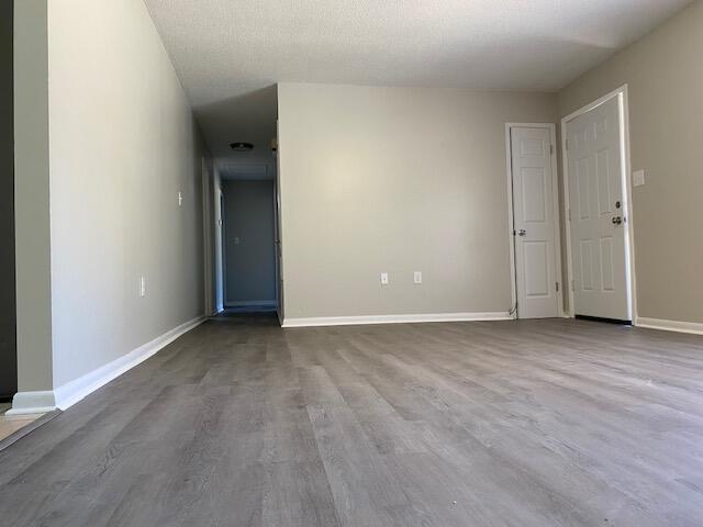 6173 Old Hickory Road Crestview, FL 32539 - Photo 2 of 22 a view of a room with wooden floor and white walls