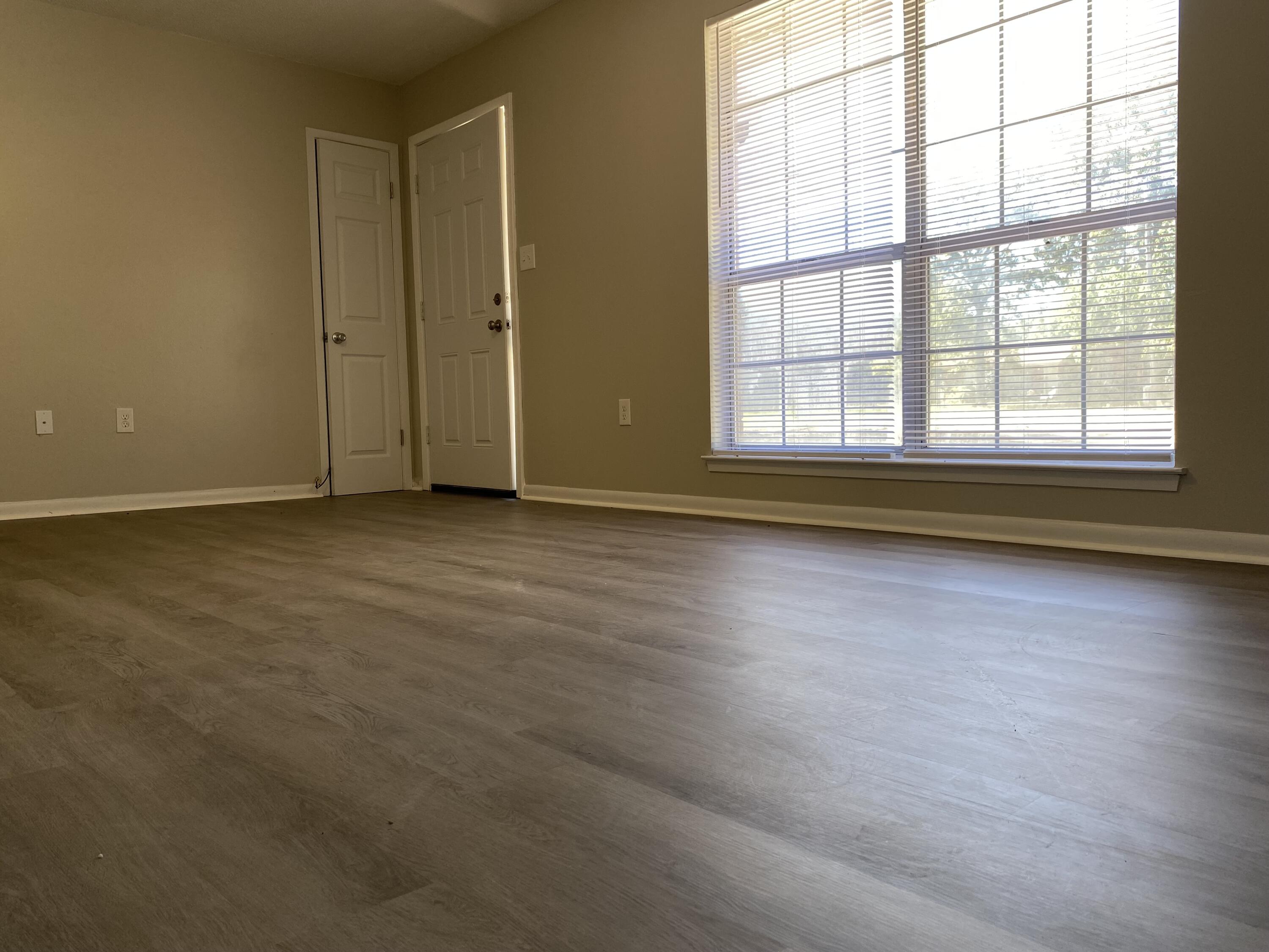 6173 Old Hickory Road Crestview, FL 32539 - Photo 4 of 22 an empty room with wooden floor and windows