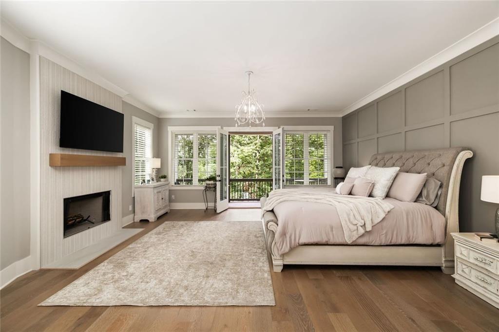 9370 Raldon Road Gainesville, GA 30506 - Photo 19 of 67 a spacious bedroom with a large bed and a fireplace