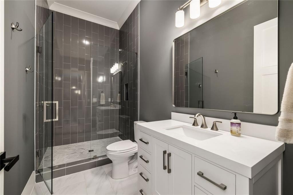 9370 Raldon Road Gainesville, GA 30506 - Photo 29 of 67 a bathroom with a sink a toilet and shower