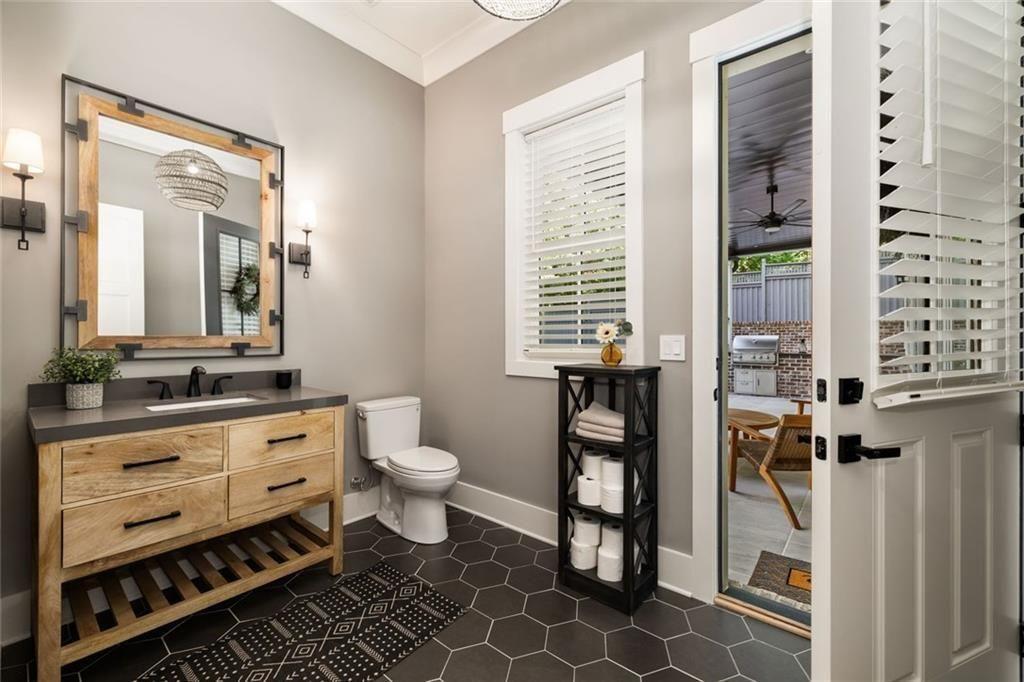 9370 Raldon Road Gainesville, GA 30506 - Photo 42 of 67 a bathroom with a toilet sink and a mirror