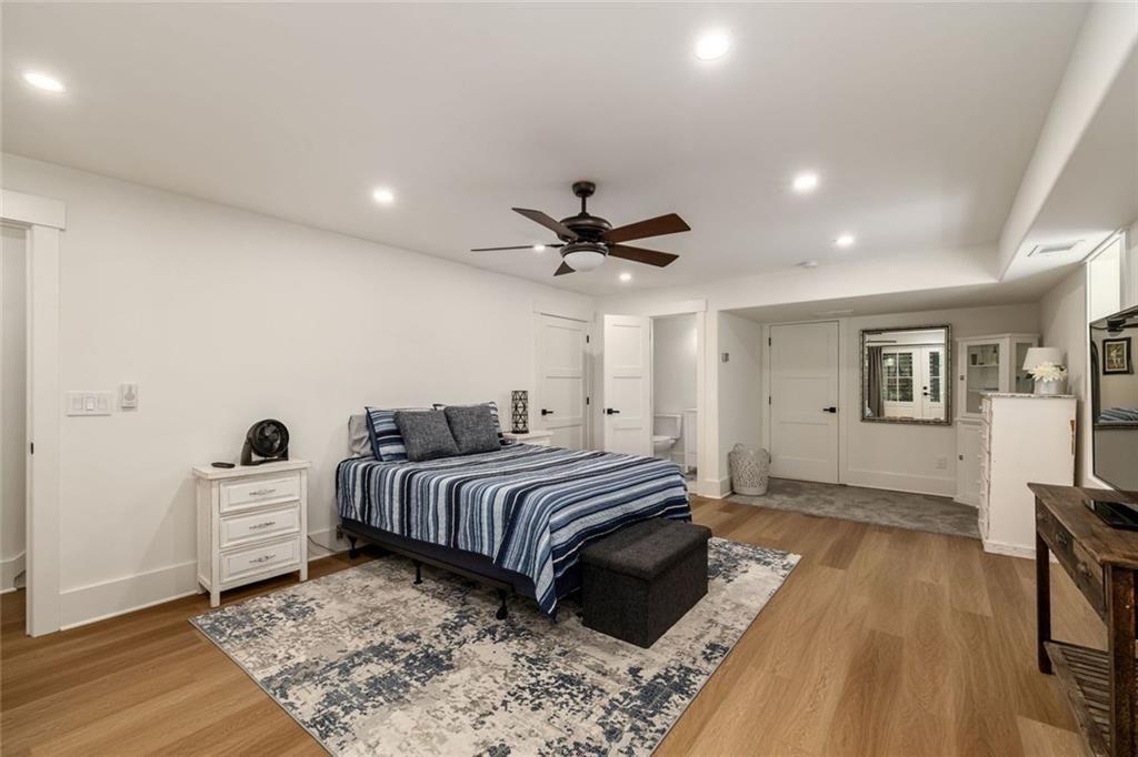 9370 Raldon Road Gainesville, GA 30506 - Photo 54 of 67 a bedroom with a bed and a chandelier