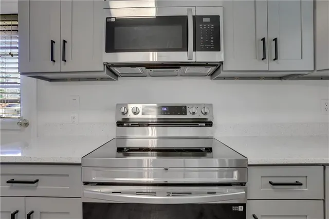 a stove top oven sitting inside of a kitchen