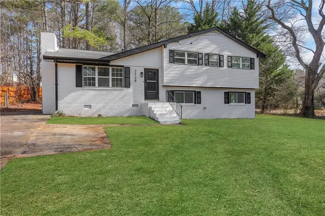 a front view of house with yard and green space