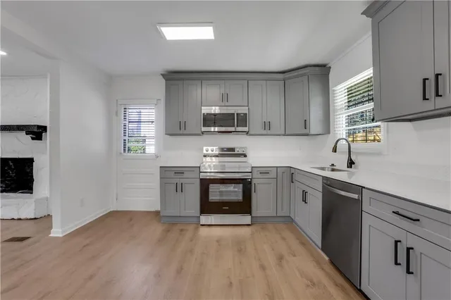 a kitchen with granite countertop a stove top oven sink and cabinets