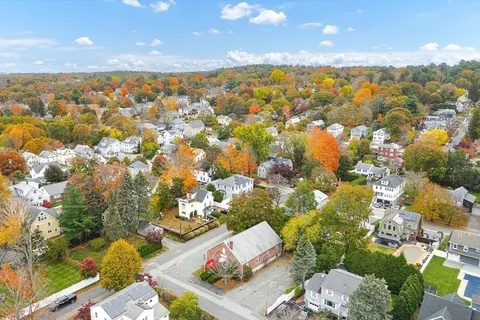 an aerial view of residential houses with outdoor space and swimming pool