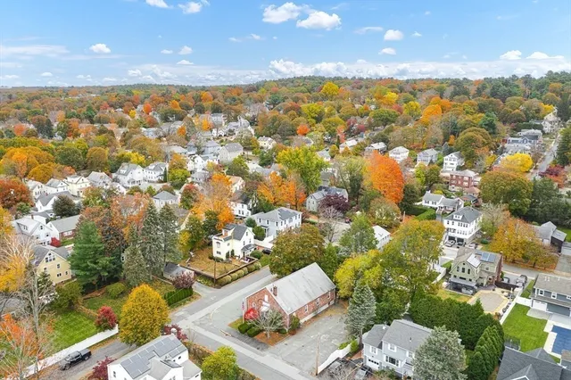 an aerial view of residential houses with outdoor space and swimming pool