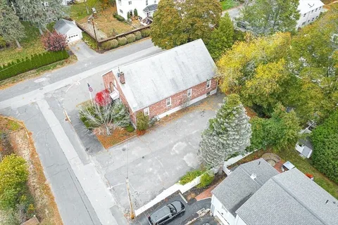 an aerial view of residential building with parking