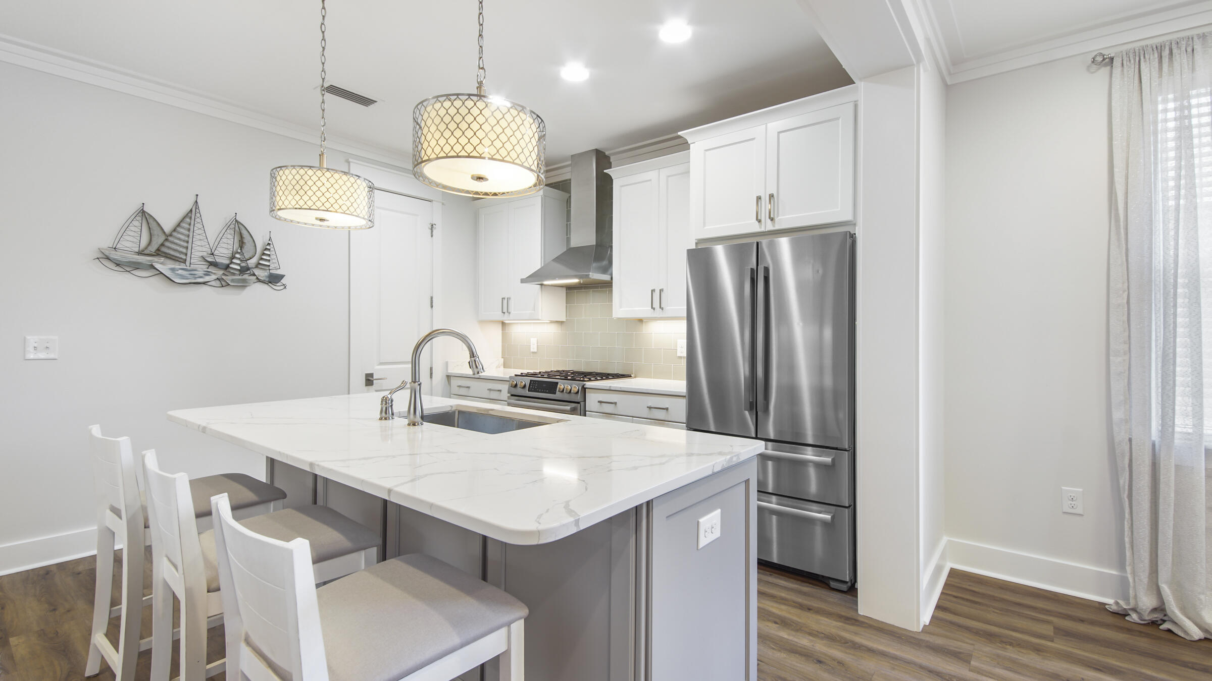 307 Sandchase Cir Inlet Beach Inlet Beach, FL 32461 - Photo 16 of 64 a kitchen with stainless steel appliances a table chairs and chandelier