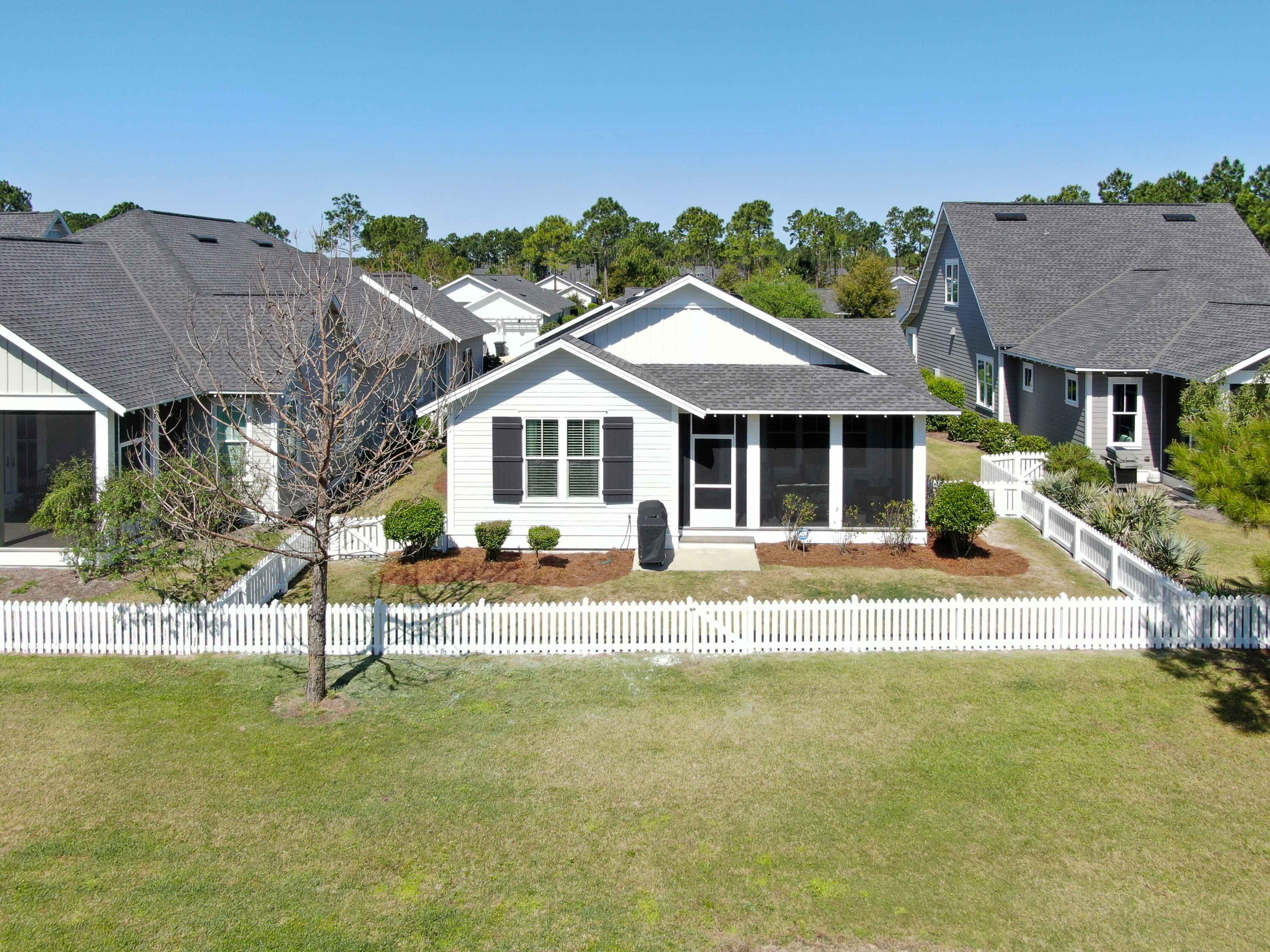 307 Sandchase Cir Inlet Beach Inlet Beach, FL 32461 - Photo 57 of 64 a house that has a table and chairs in front of it