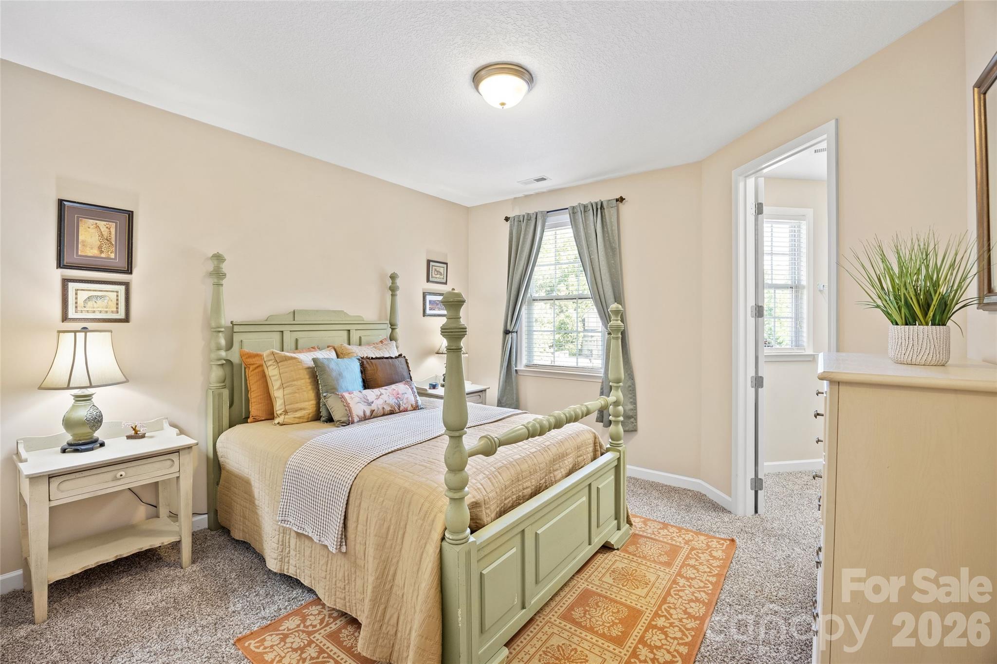 2240 Creek View Court Fort Mill, SC 29707 - Photo 23 of 40 a bedroom with a bed and a potted plant
