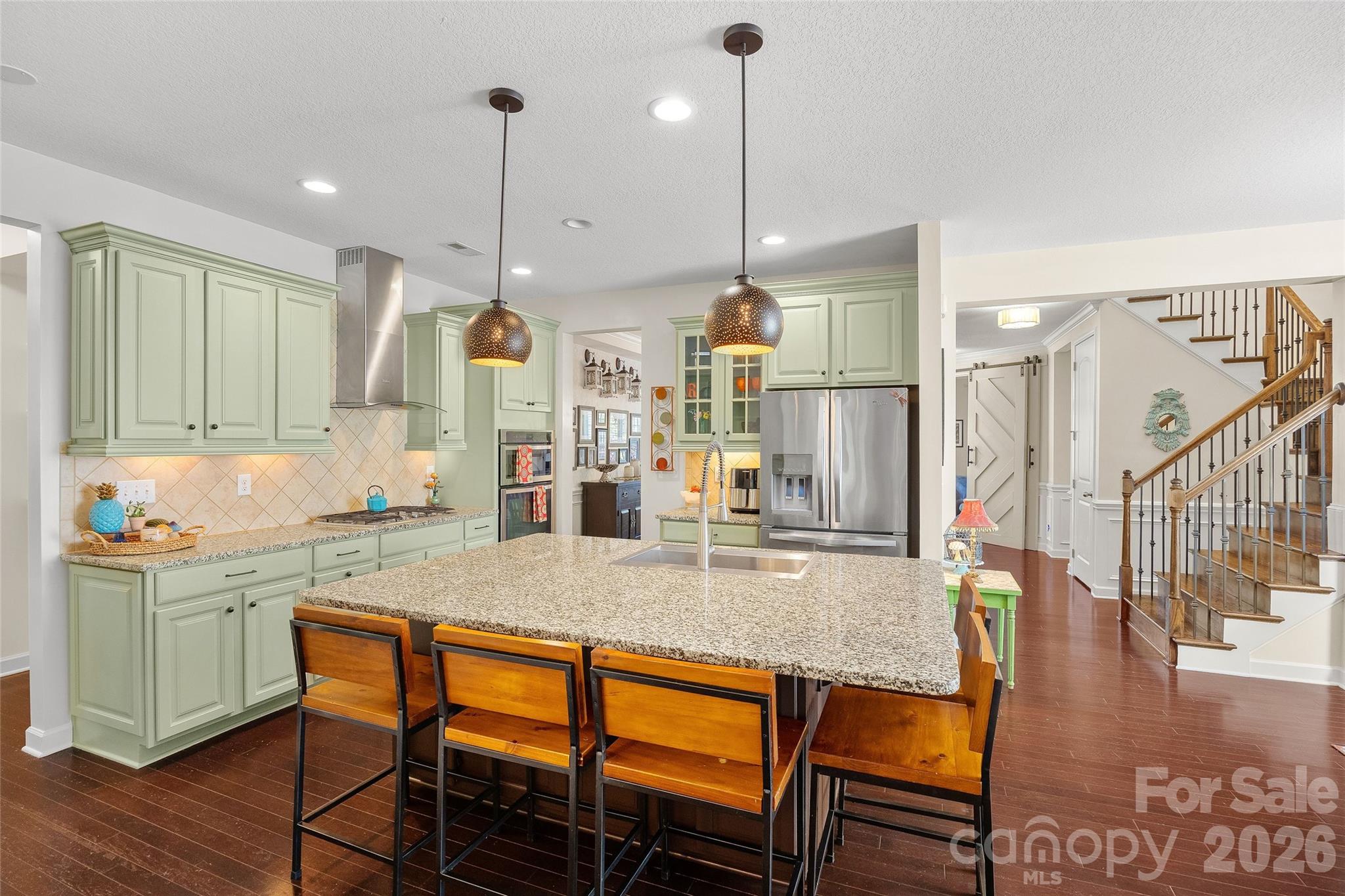 2240 Creek View Court Fort Mill, SC 29707 - Photo 7 of 40 a kitchen with stainless steel appliances granite countertop a kitchen island a stove a table and chairs