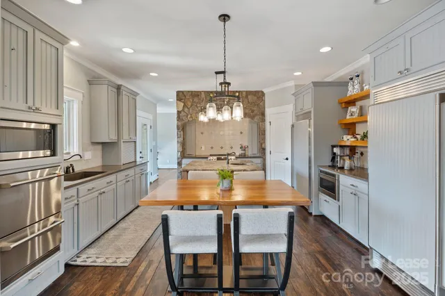 a large kitchen with granite countertop lots of counter space and window