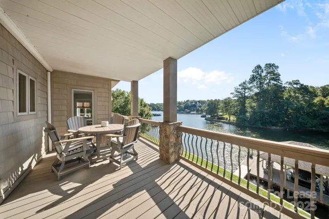 a view of balcony with wooden floor and outdoor seating