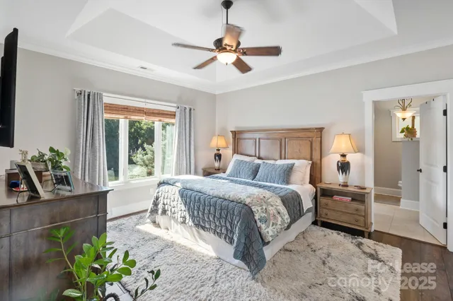 a bedroom with a bed potted plant with the outer view