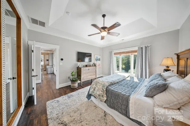 a bedroom with a bed and a chandelier