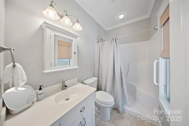a bathroom with a sink toilet tub and shower