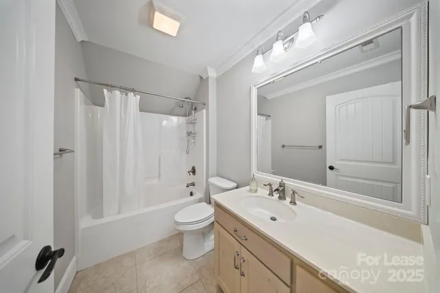 a bathroom with a double vanity sink toilet mirror and bathtub