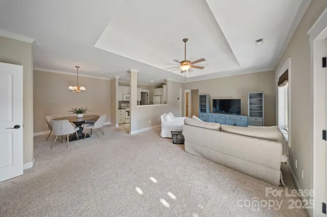 a living room with furniture and a chandelier