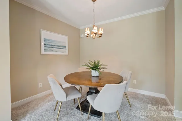 a view of a dining room with furniture and chandelier