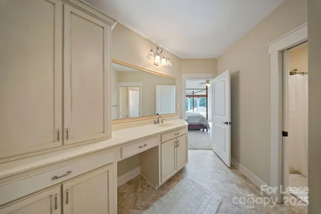 a spacious bathroom with a granite countertop sink and mirror