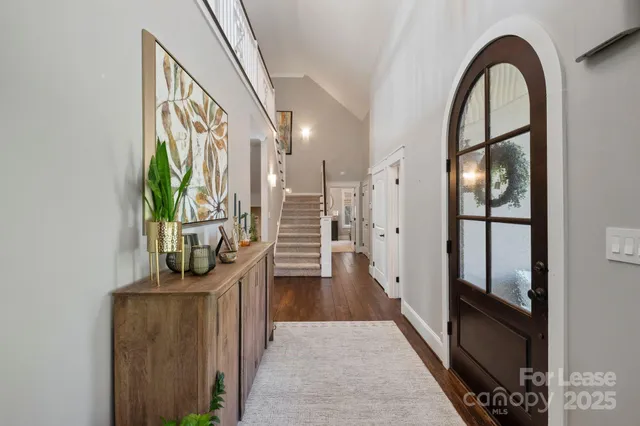 a view of entryway and hall with wooden floor