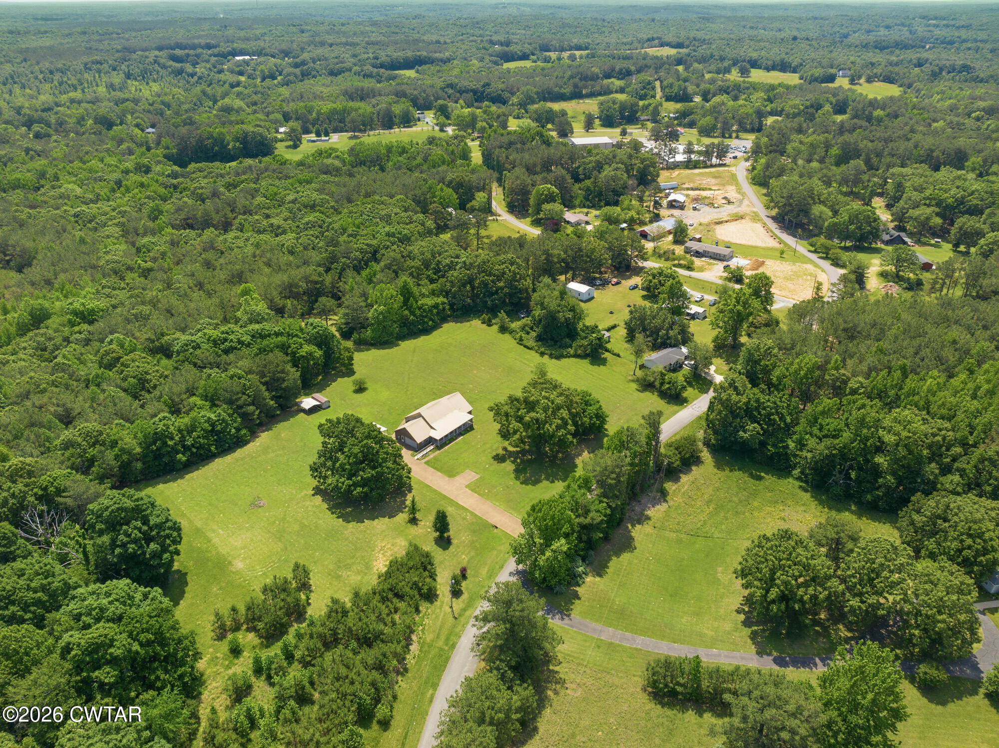 492 Joe Horton Road Lexington, TN 38351 - Photo 38 of 49 an aerial view of residential houses with outdoor space and trees