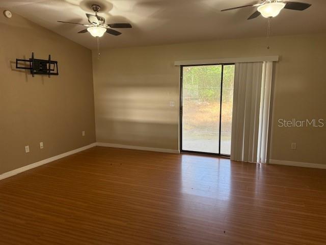306 Cabot Street Inverness, FL 34452 - Photo 2 of 10 an empty room with wooden floor fan and windows