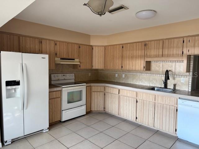 306 Cabot Street Inverness, FL 34452 - Photo 4 of 10 a kitchen with a white cabinets and white appliances