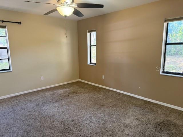 306 Cabot Street Inverness, FL 34452 - Photo 6 of 10 an empty room with windows and fan
