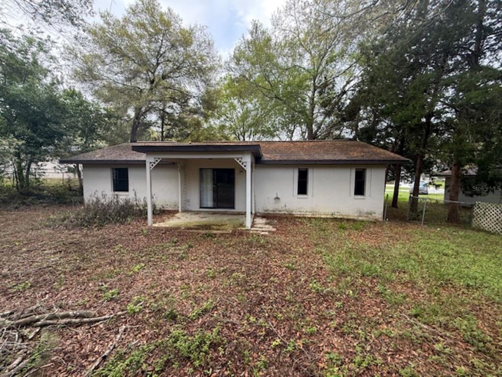 306 Cabot Street Inverness, FL 34452 - Photo 10 of 10 a house with trees in the background