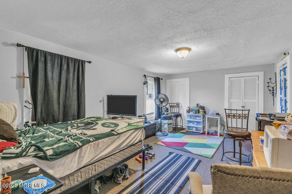 401 Joline Avenue Long Branch, NJ 07740 - Photo 15 of 30 a bedroom with a bed and a table in it