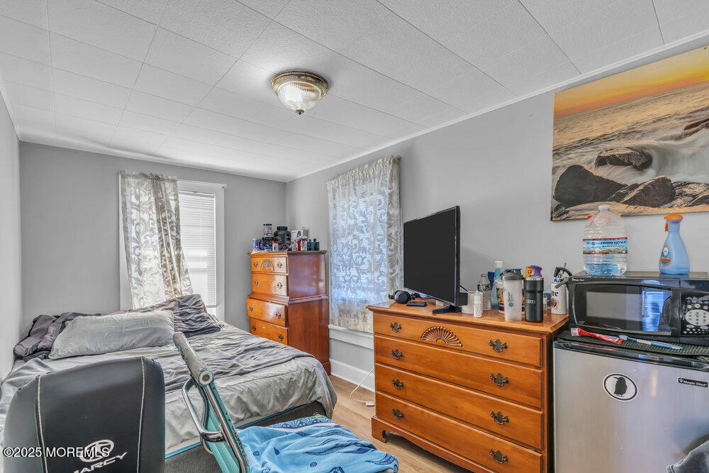401 Joline Avenue Long Branch, NJ 07740 - Photo 16 of 30 a bedroom with furniture and a flat screen tv