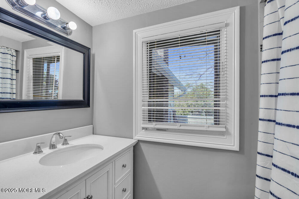401 Joline Avenue Long Branch, NJ 07740 - Photo 17 of 30 a bathroom with a sink a vanity and a mirror